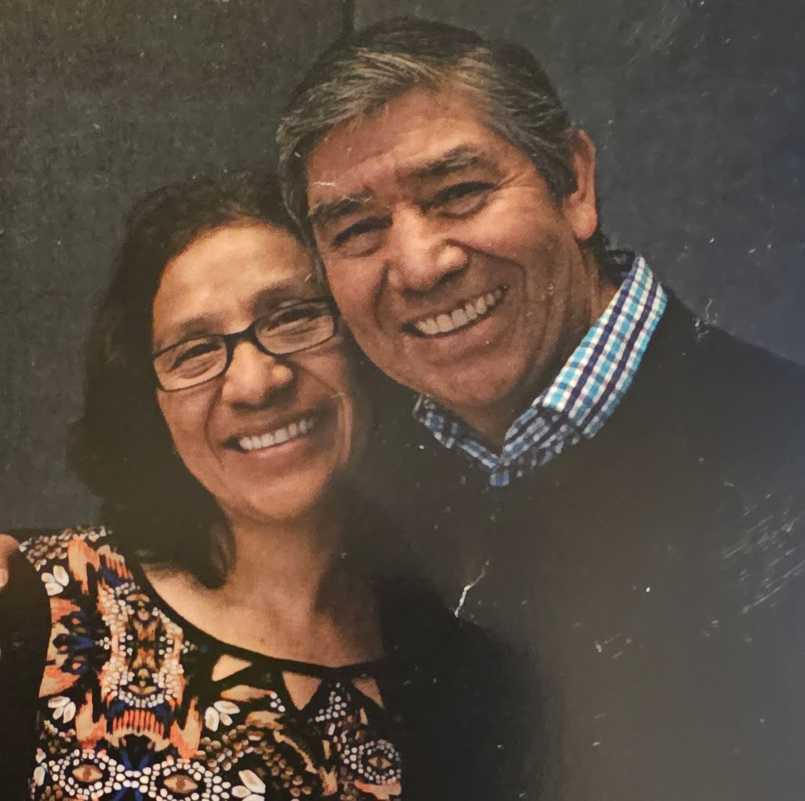 Hely in glasses and her husband José, heads together, both smiling